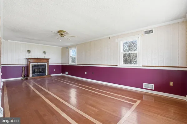 a view of livingroom with furniture fireplace and window