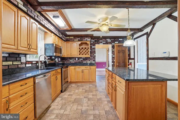 a kitchen with stainless steel appliances granite countertop a sink and counter space