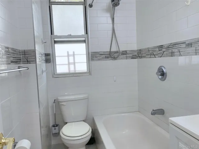 a bathroom with a toilet a sink and bathtub
