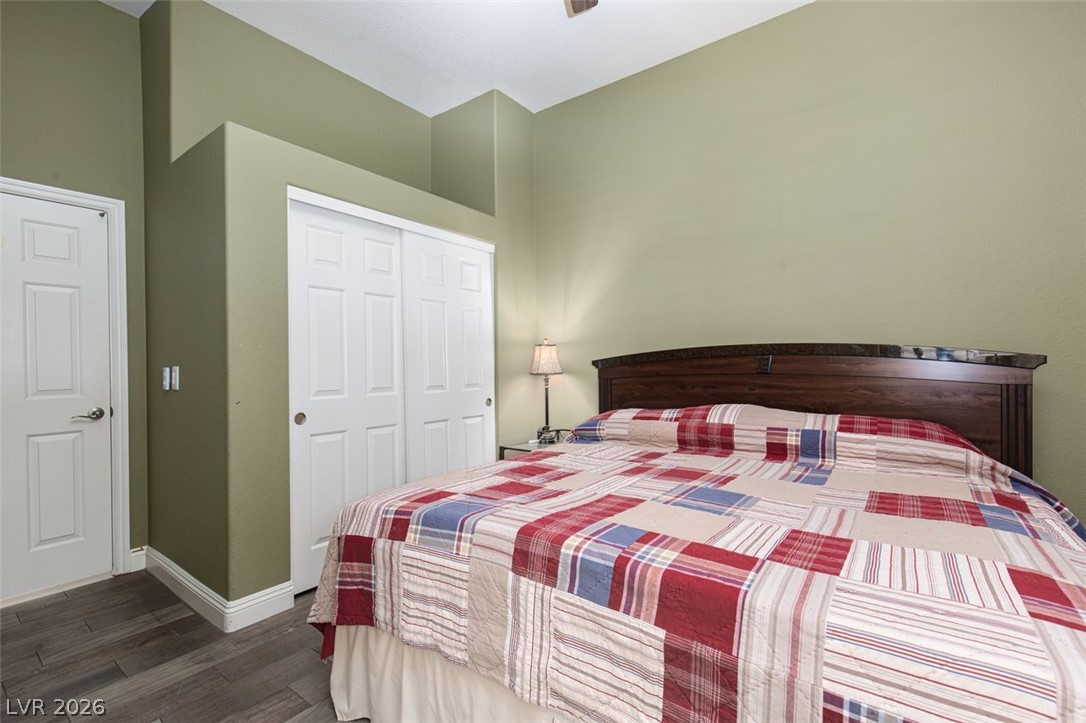 4670 Los Rancheros Avenue Las Vegas, NV 89129 - Photo 33 of 57 High ceilings and modern wood-look flooring enhance this comfortable bedroom design.