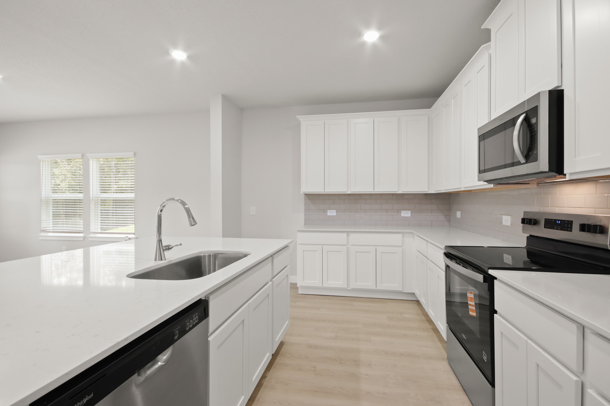 129 Byu Bnd Boulevard Angleton, TX 77515 - Photo 4 of 25 a kitchen with stainless steel appliances granite countertop a sink and stove top oven
