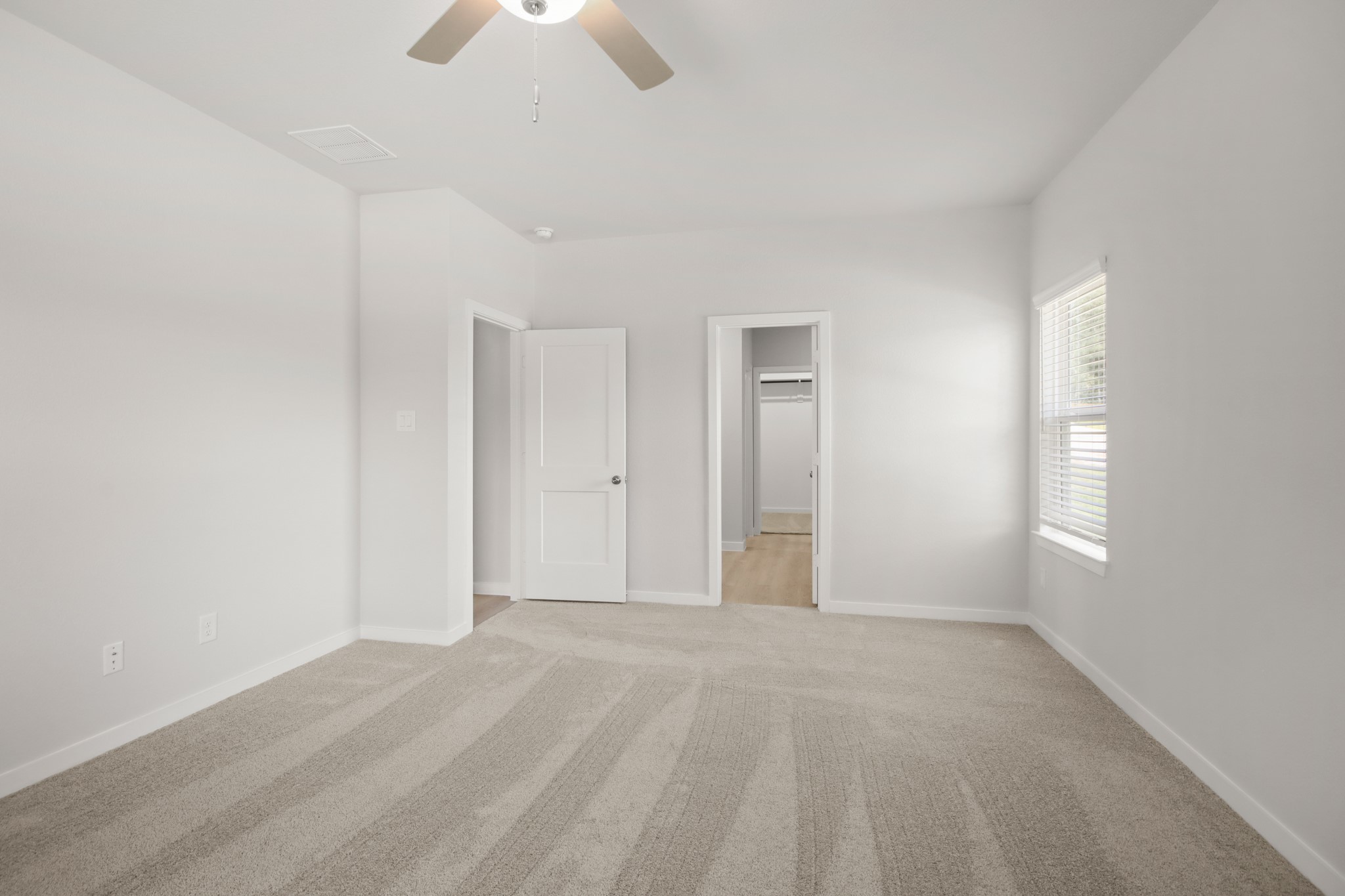 129 Byu Bnd Boulevard Angleton, TX 77515 - Photo 8 of 25 an empty room with chandelier fan and windows