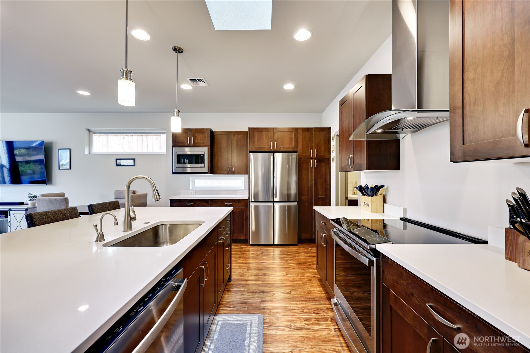90 Village Green Sequim, WA 98382 - Photo 12 of 40 a kitchen with counter top space a sink stainless steel appliances and cabinets