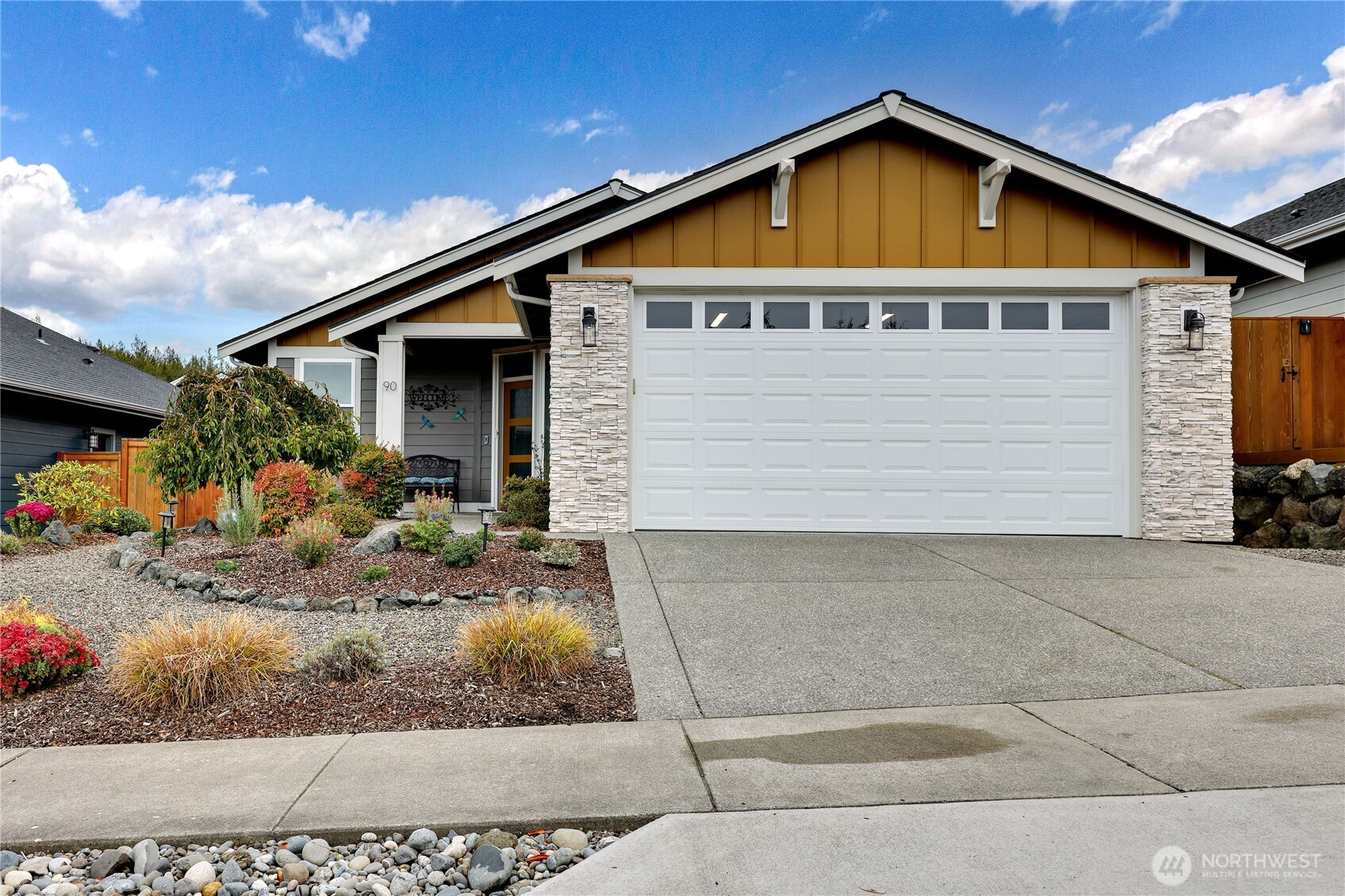 90 Village Green Sequim, WA 98382 - Photo 2 of 40 a front view of a house with garden