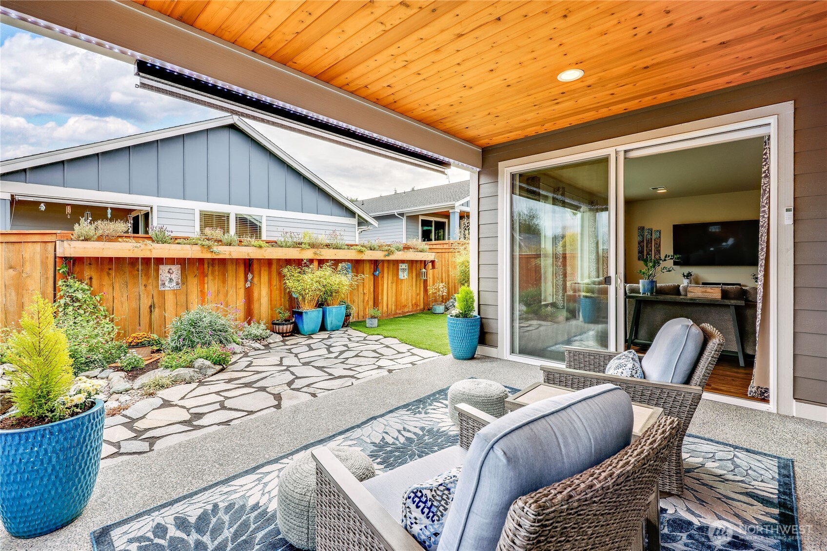 90 Village Green Sequim, WA 98382 - Photo 27 of 40 a view of a patio with couches chairs and potted plants