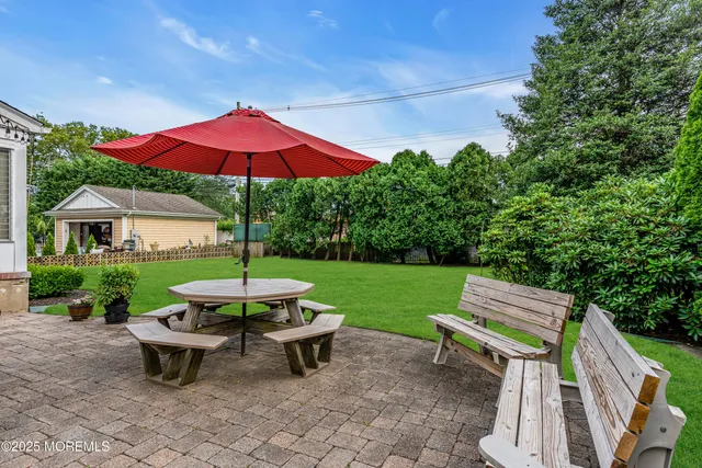 a view of a backyard with sitting area