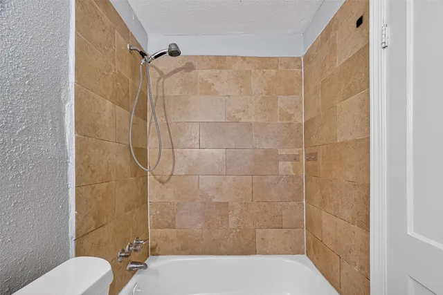 a bathroom with a shower and a toilet