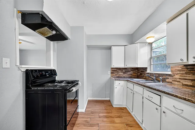 a kitchen with stainless steel appliances a sink and a stove