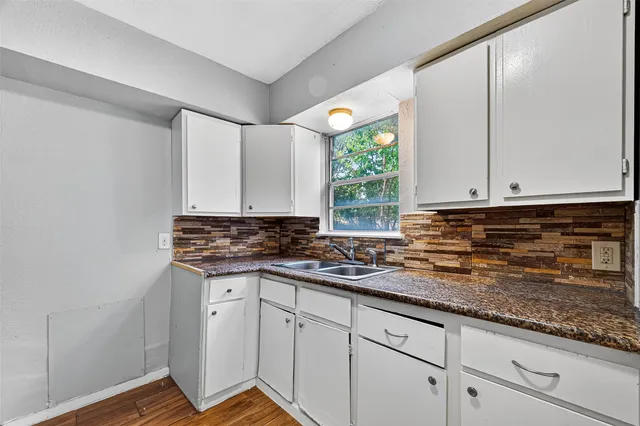 a kitchen with stainless steel appliances granite countertop a sink and a stove