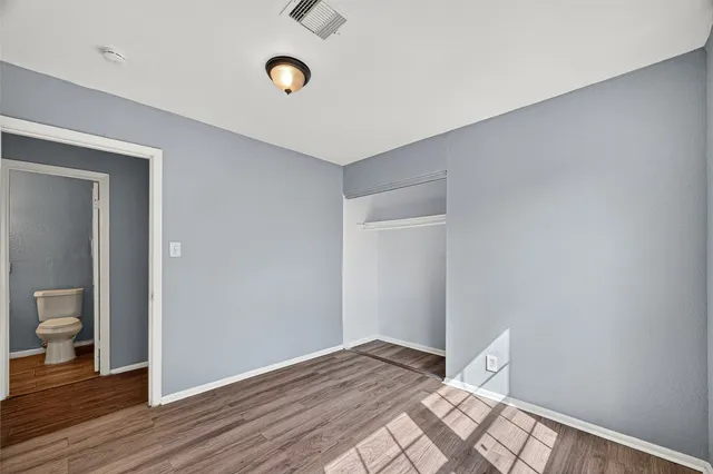 a view of a room with wooden floor and bathroom