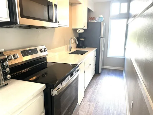 a spacious bedroom with a bed and window