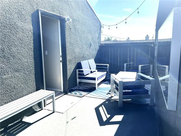 a view of a balcony with table and chairs