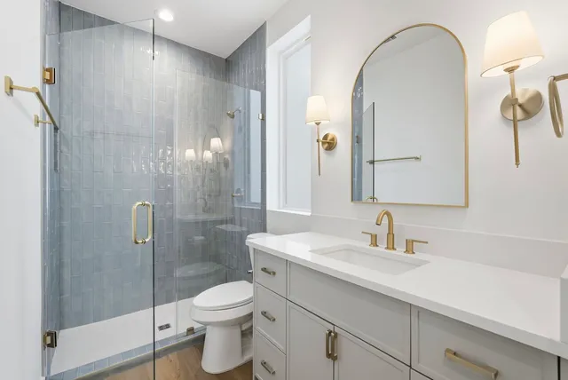 a bathroom with a toilet a sink and shower