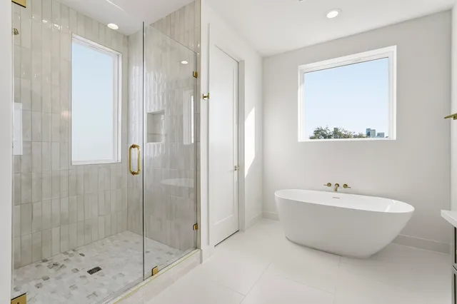 a bathroom with a bathtub and shower