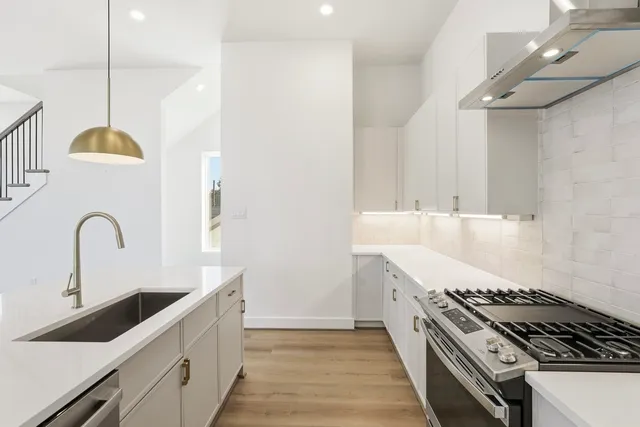 a kitchen with granite countertop a stove and a sink