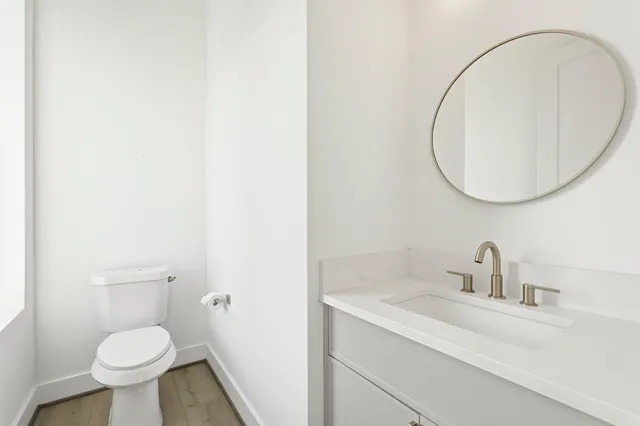a bathroom with a sink toilet and a mirror