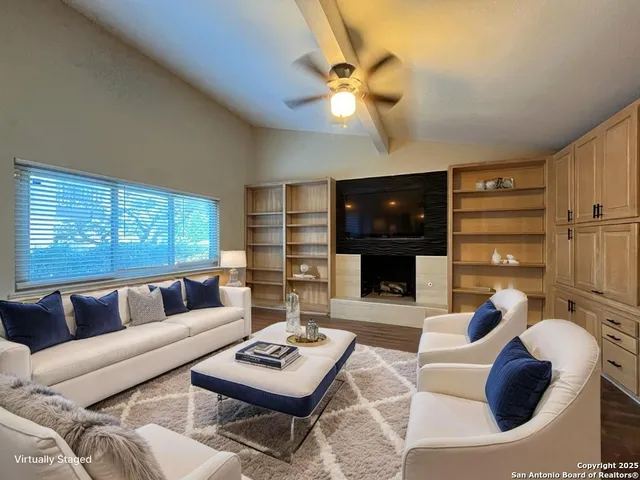 a living room with furniture and a fireplace