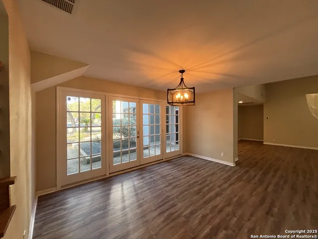 a backyard of a house with outdoor seating and trees