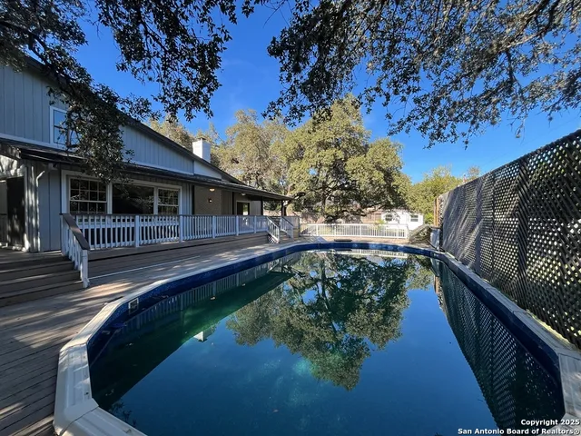 a view of a yard with large trees