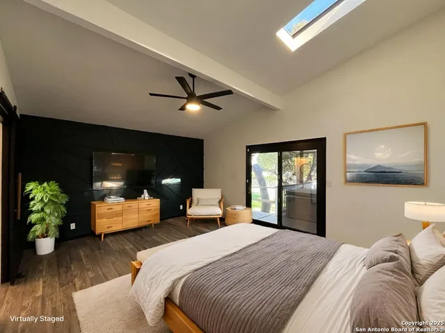 a bedroom with a bed and a large window