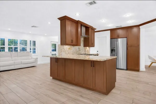 a kitchen with granite countertop cabinets stainless steel appliances and a counter space