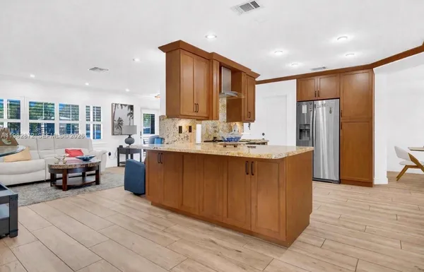 a kitchen with stainless steel appliances a stove a refrigerator and cabinets
