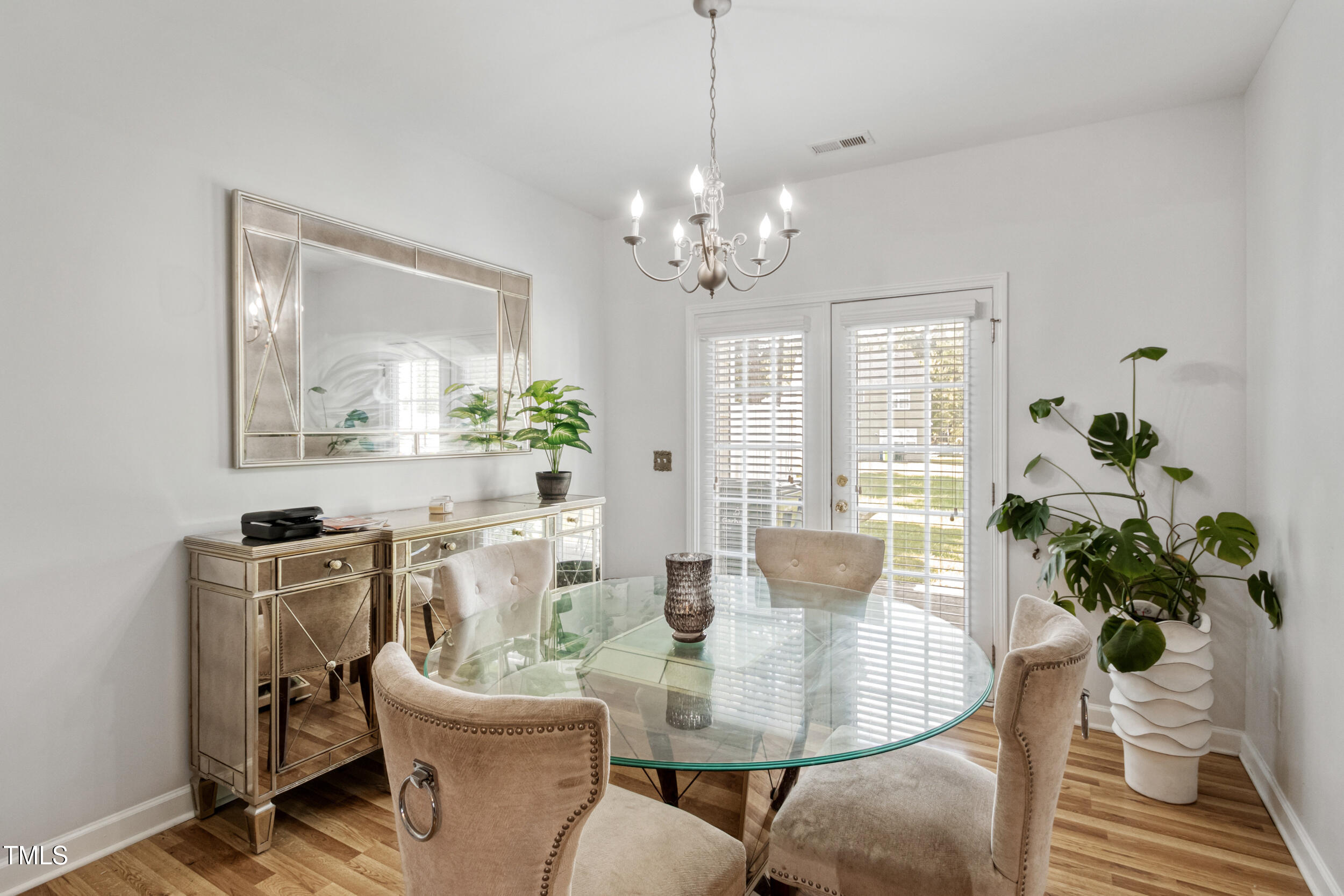 6113 Neuse Wood Drive Raleigh, NC 27616 - Photo 10 of 29 a dining room with furniture potted plants and wooden floor