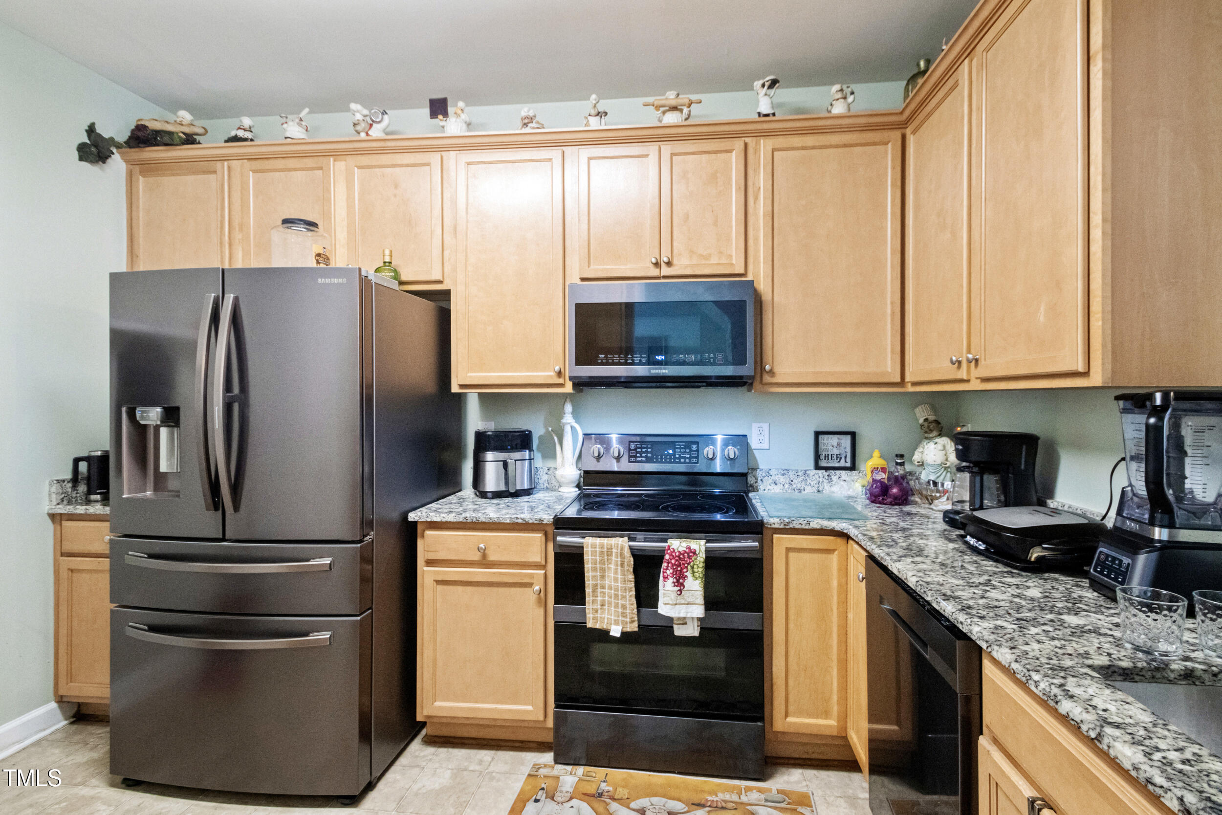 6113 Neuse Wood Drive Raleigh, NC 27616 - Photo 12 of 29 a kitchen with stainless steel appliances granite countertop a refrigerator stove and sink