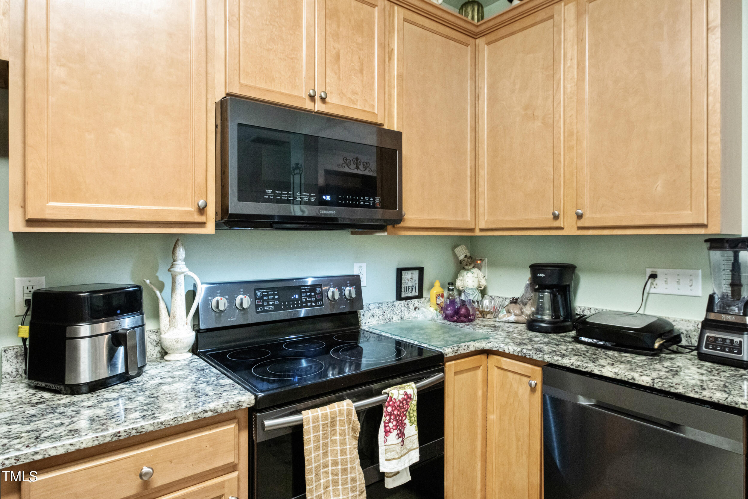 6113 Neuse Wood Drive Raleigh, NC 27616 - Photo 14 of 29 a kitchen with stainless steel appliances granite countertop a stove and a microwave