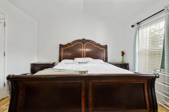 a bedroom with a bed and a mirror