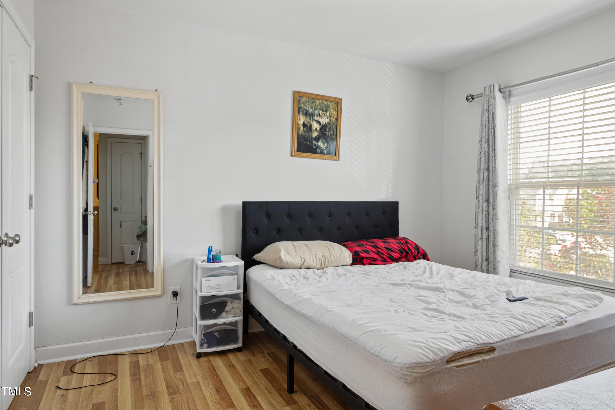 6113 Neuse Wood Drive Raleigh, NC 27616 - Photo 22 of 29 a bedroom with a bed and wooden floor