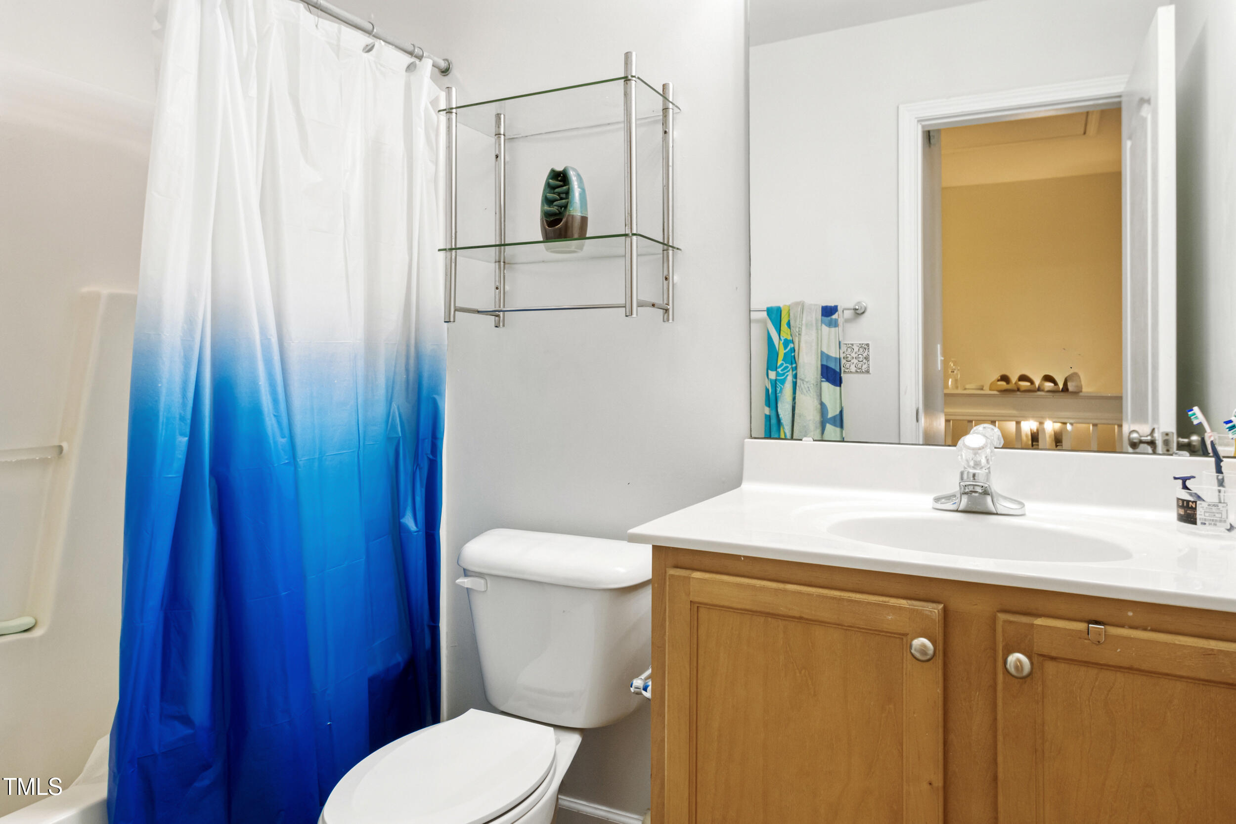 6113 Neuse Wood Drive Raleigh, NC 27616 - Photo 23 of 29 a bathroom with a sink a toilet and shower curtain