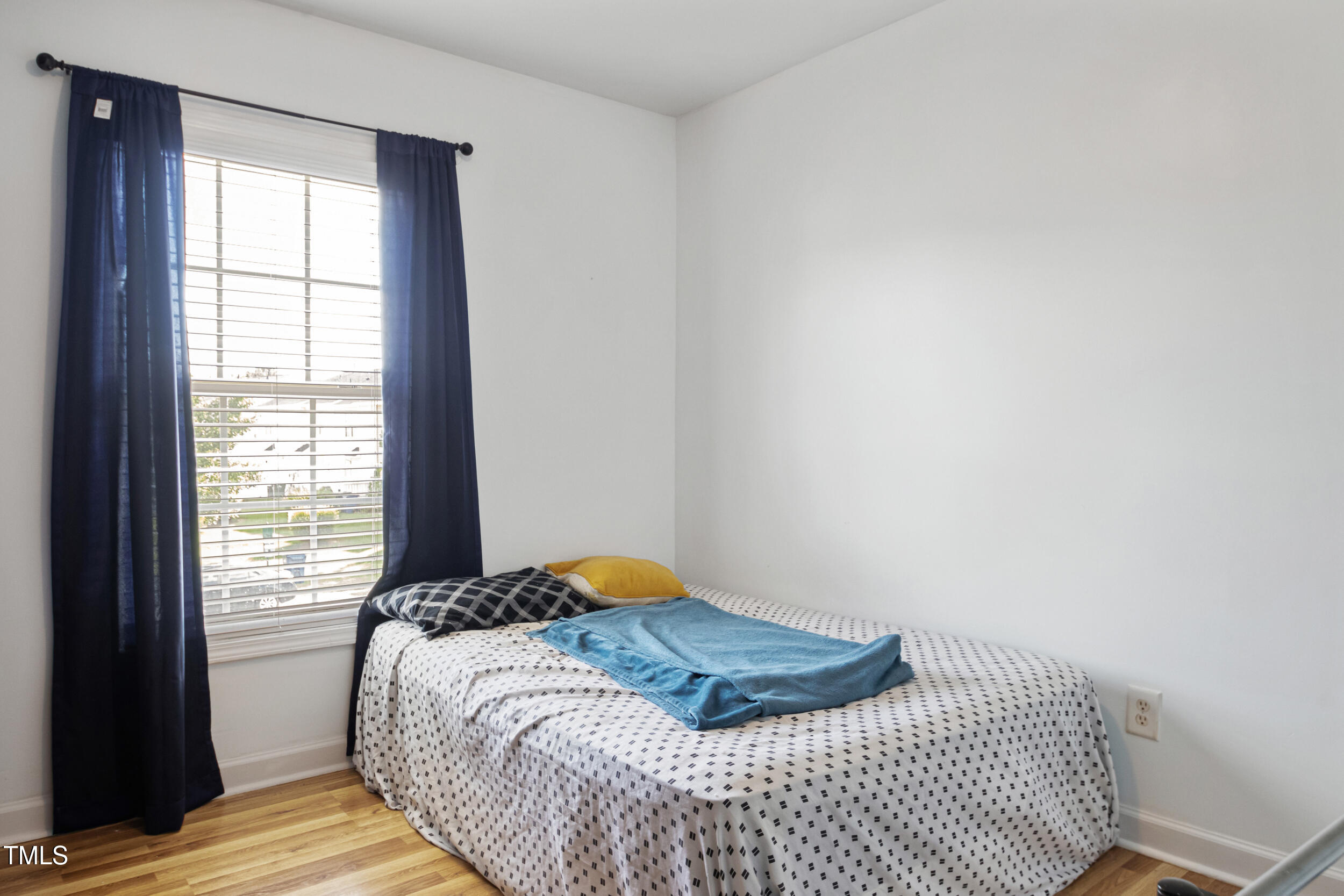 6113 Neuse Wood Drive Raleigh, NC 27616 - Photo 24 of 29 a bedroom with a bed and wooden floor