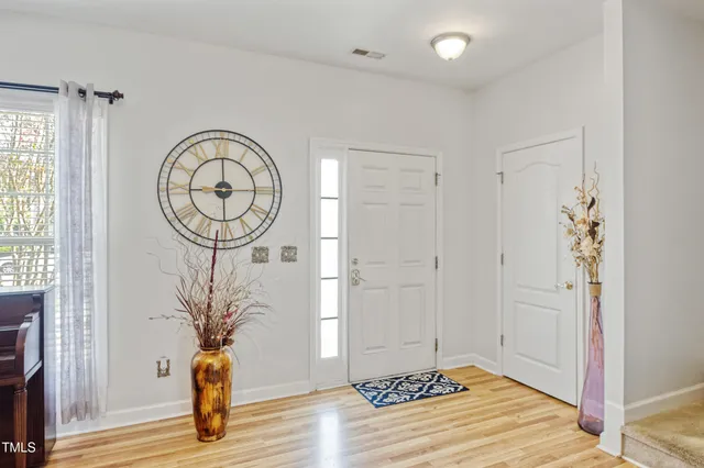 a front view of a house with plants
