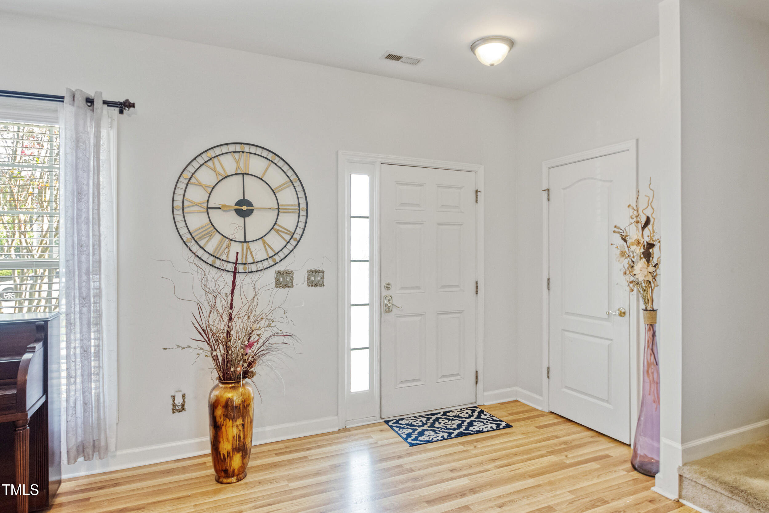 6113 Neuse Wood Drive Raleigh, NC 27616 - Photo 3 of 29 a view of a hallway with wooden floor and a potted plant