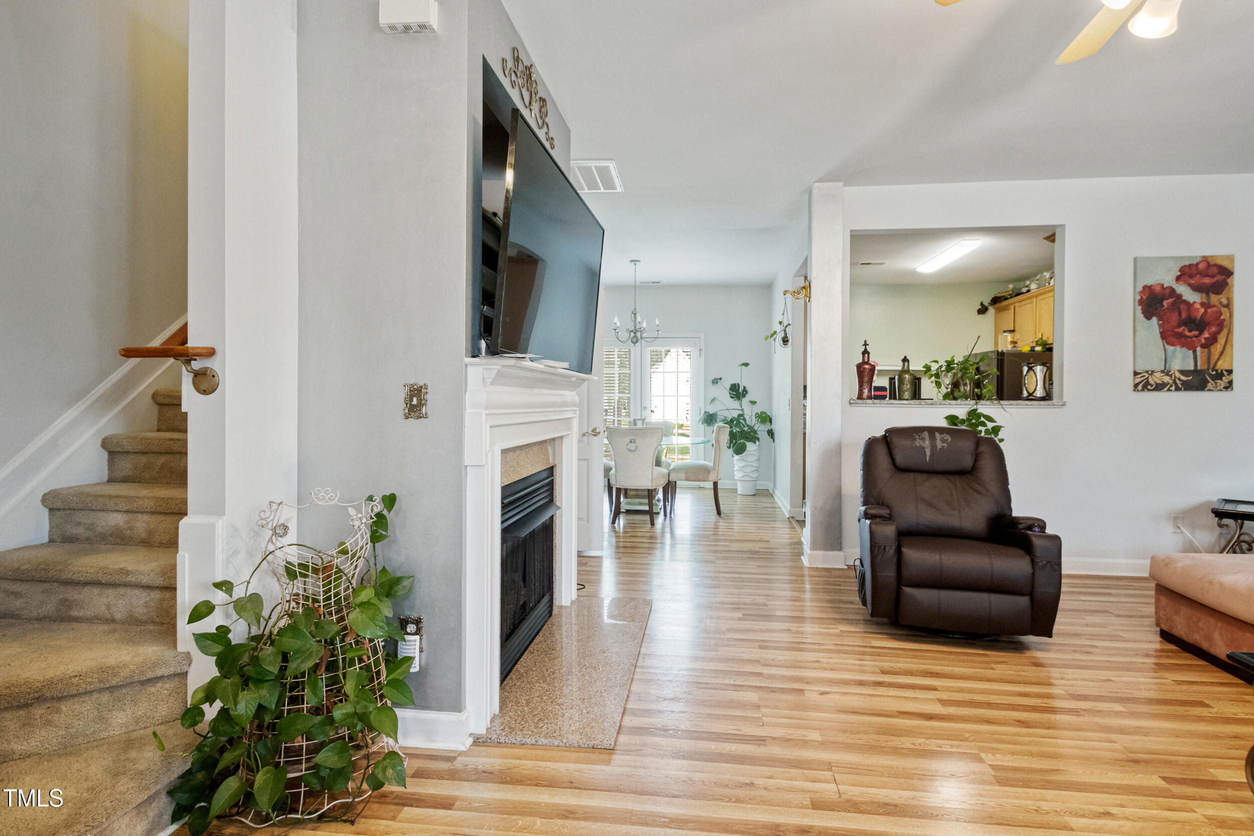 6113 Neuse Wood Drive Raleigh, NC 27616 - Photo 5 of 29 a living room with furniture a fireplace and a potted plant