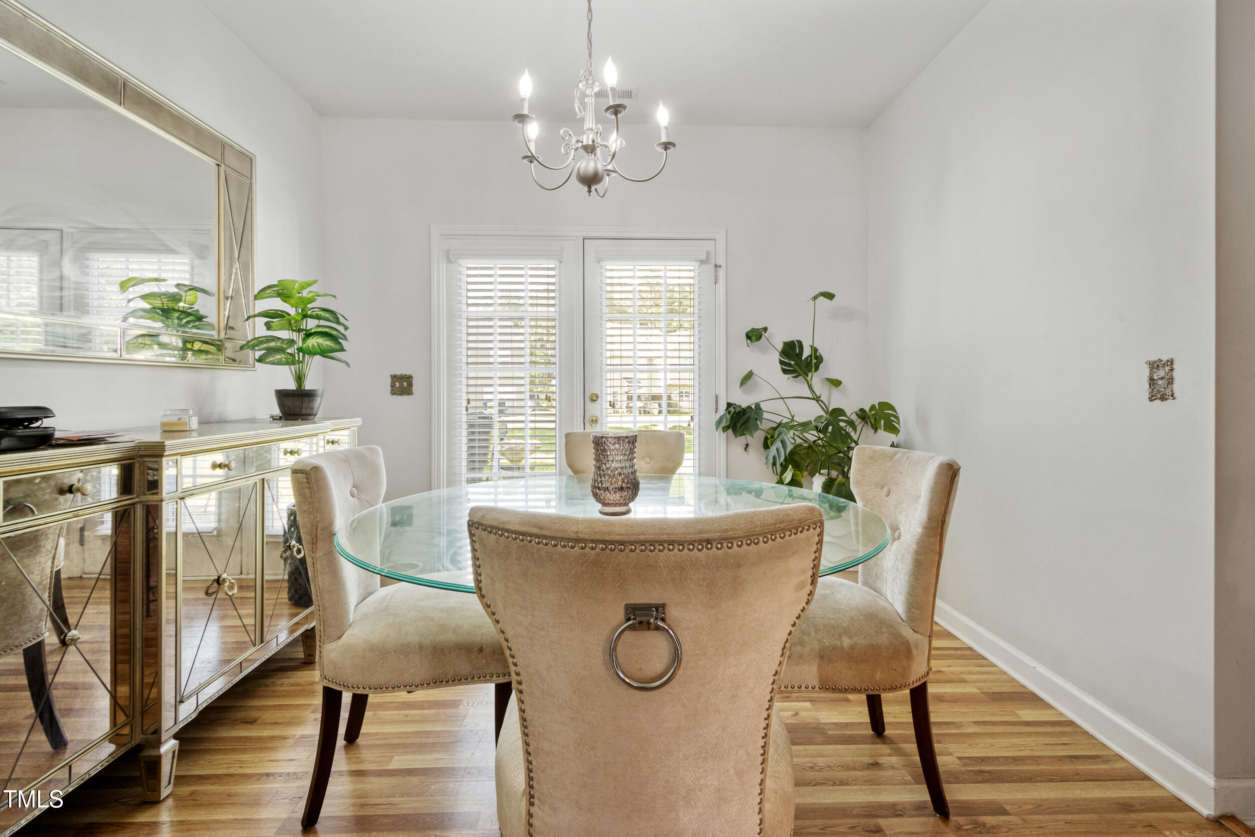 6113 Neuse Wood Drive Raleigh, NC 27616 - Photo 9 of 29 a dining room with furniture potted plants and wooden floor