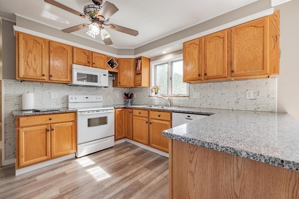 146 Bromley Road Chester, MA 01050 - Photo 8 of 40 a kitchen with stainless steel appliances granite countertop a sink a stove cabinets and wooden floor