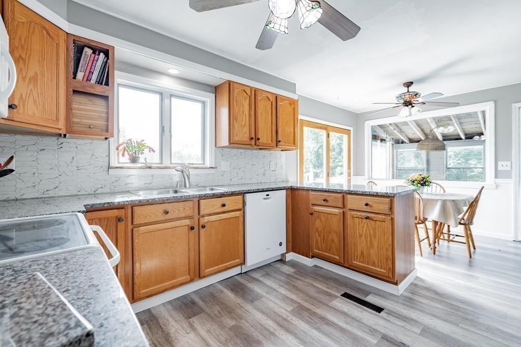 146 Bromley Road Chester, MA 01050 - Photo 10 of 40 a kitchen with stainless steel appliances granite countertop wooden floors and granite counter tops