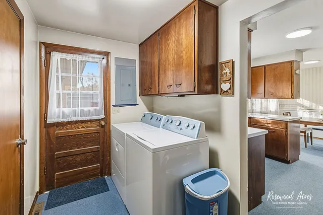 a view of a workspace with wooden floor and a window