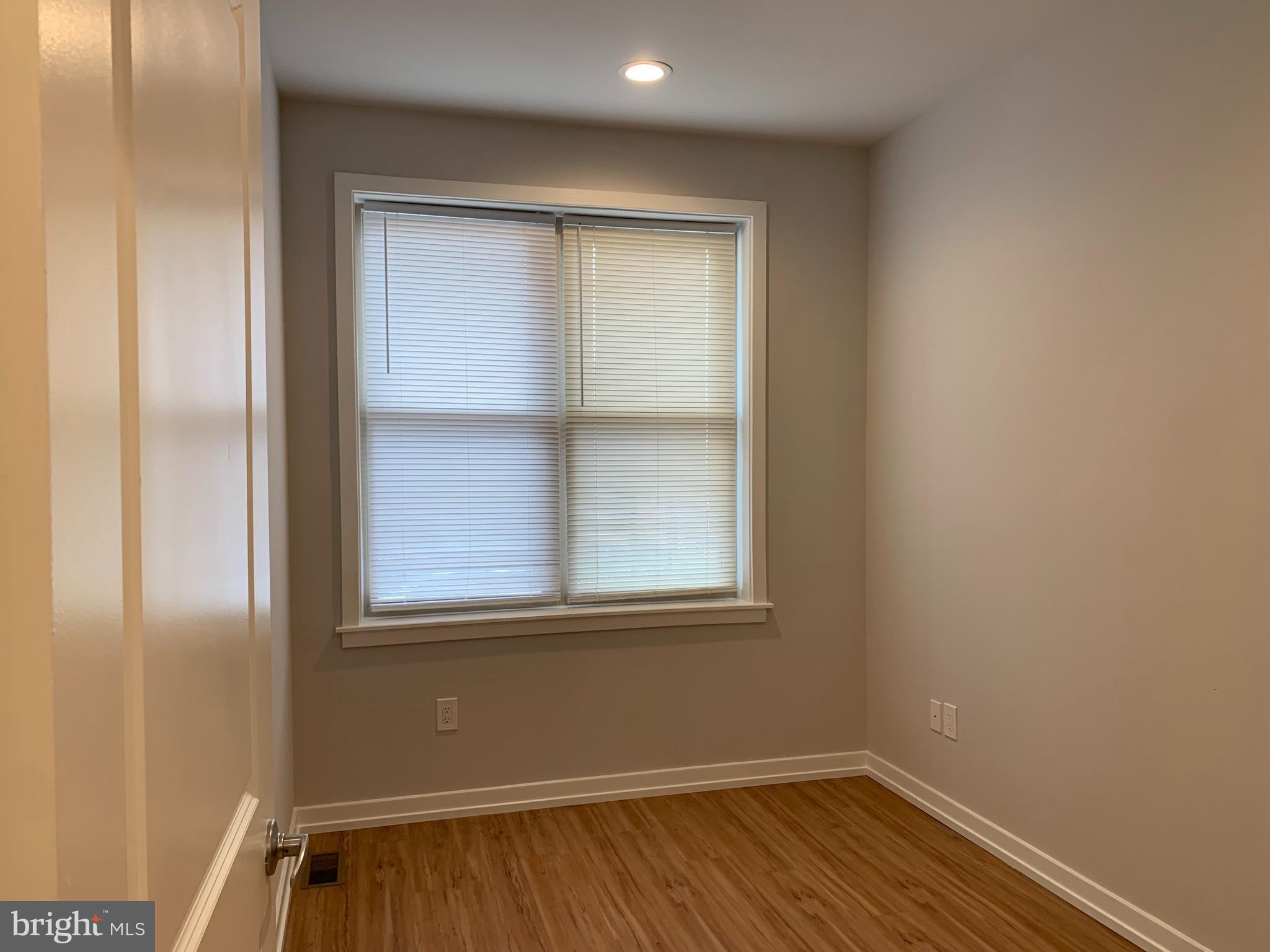 1268 South 27th Street, Unit 1 Philadelphia, PA 19146 - Photo 11 of 26 a view of an empty room with wooden floor and a window