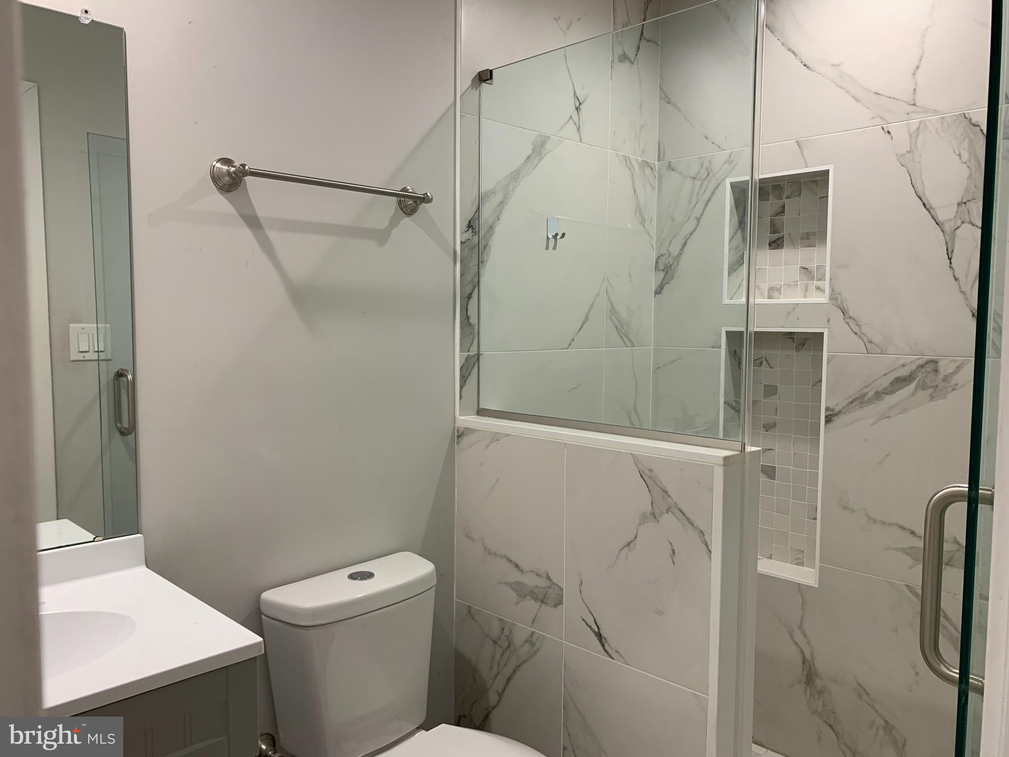 1268 South 27th Street, Unit 1 Philadelphia, PA 19146 - Photo 12 of 26 a bathroom with a shower and toilet