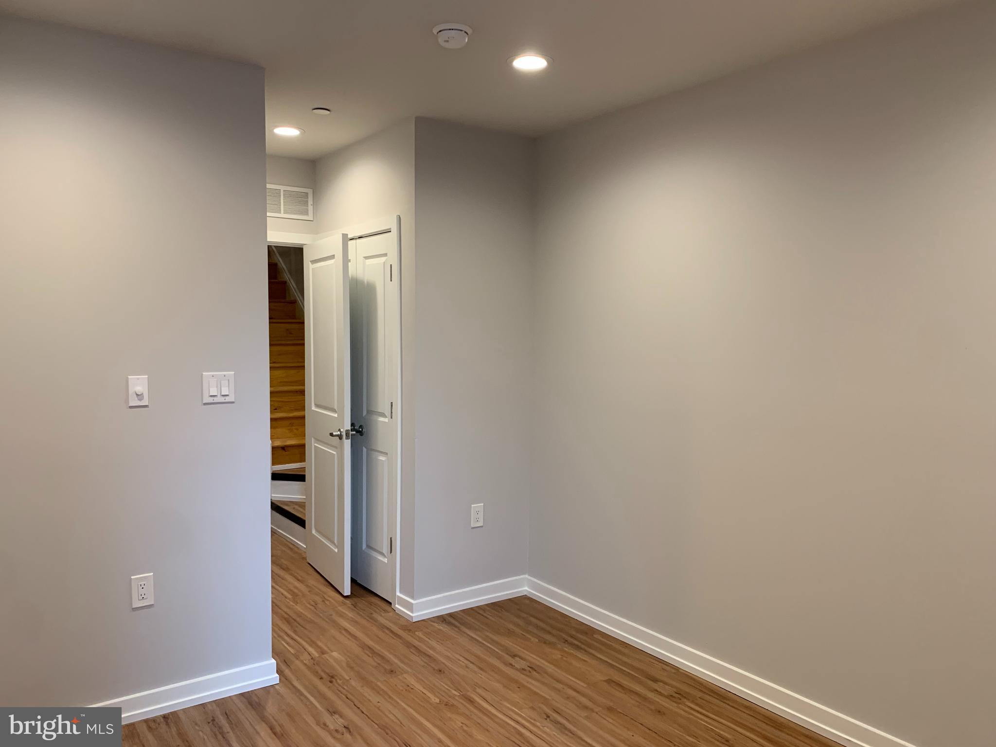 1268 South 27th Street, Unit 1 Philadelphia, PA 19146 - Photo 13 of 26 an empty room with wooden floor and entrance