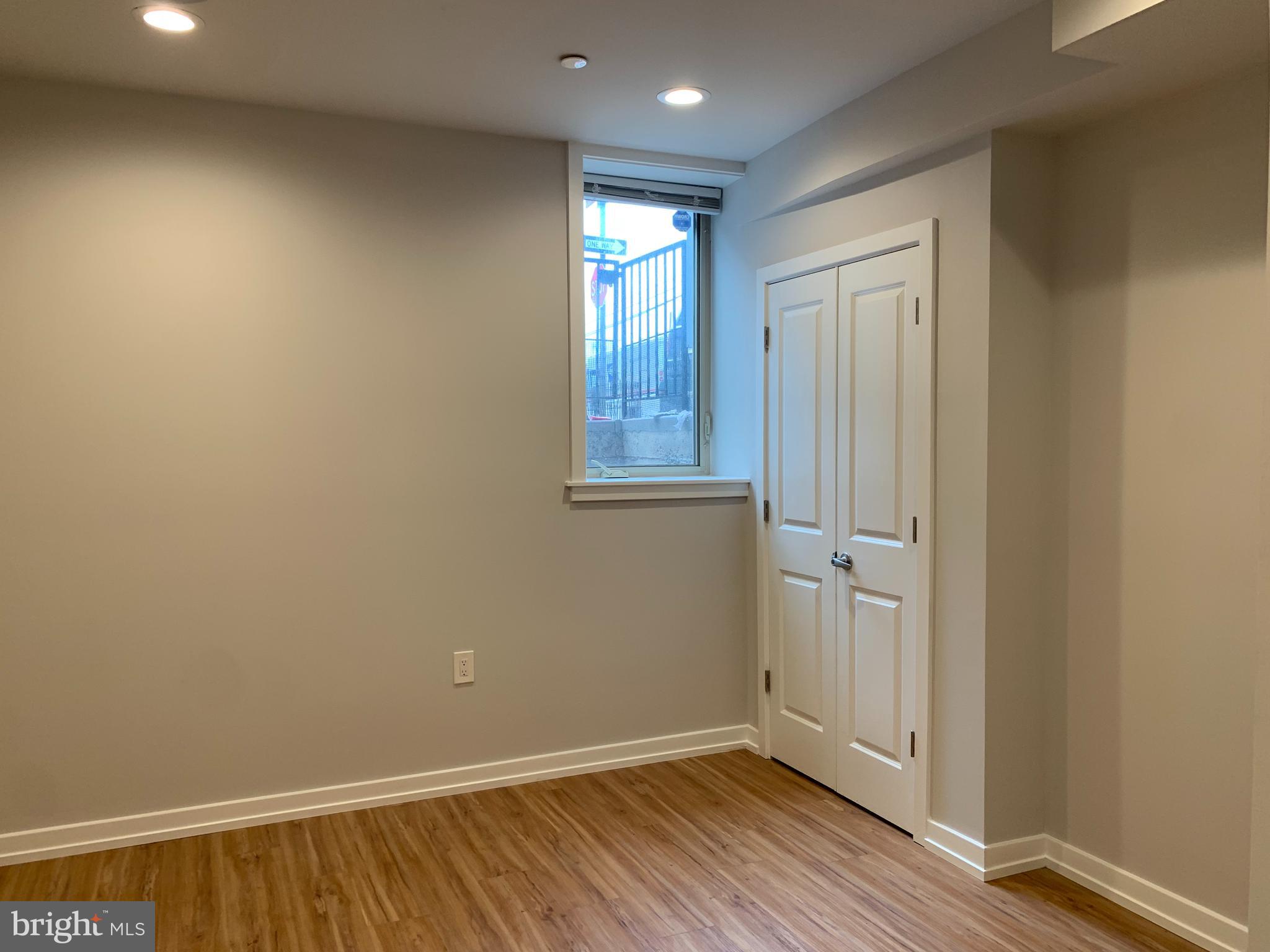 1268 South 27th Street, Unit 1 Philadelphia, PA 19146 - Photo 15 of 26 a view of an empty room with wooden floor and a window