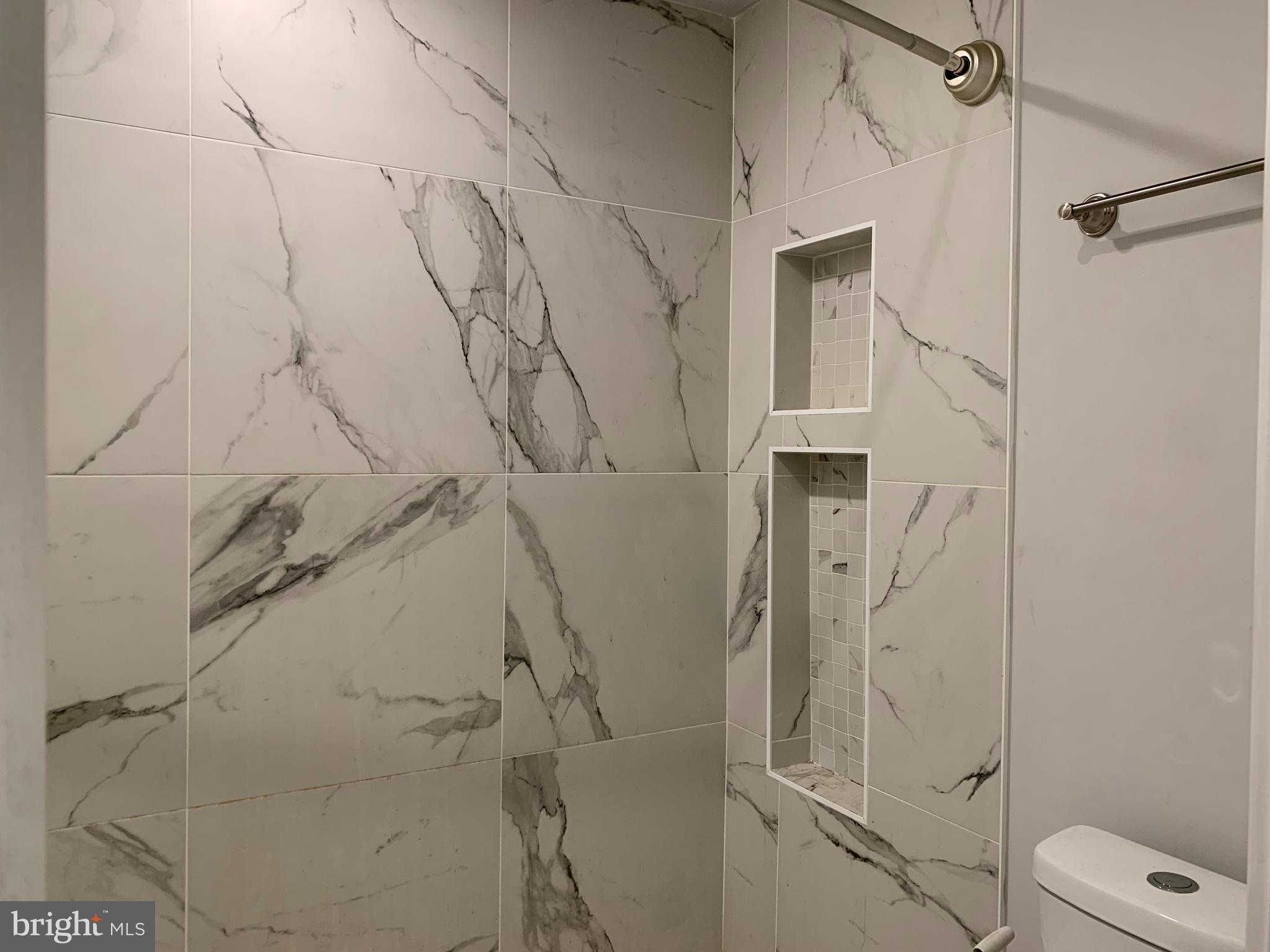 1268 South 27th Street, Unit 1 Philadelphia, PA 19146 - Photo 18 of 26 a bathroom with a shower and toilet
