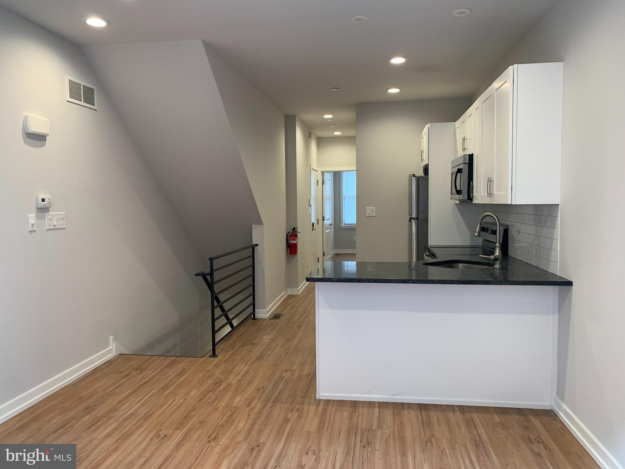 1268 South 27th Street, Unit 1 Philadelphia, PA 19146 - Photo 2 of 26 a view of a kitchen with wooden floor