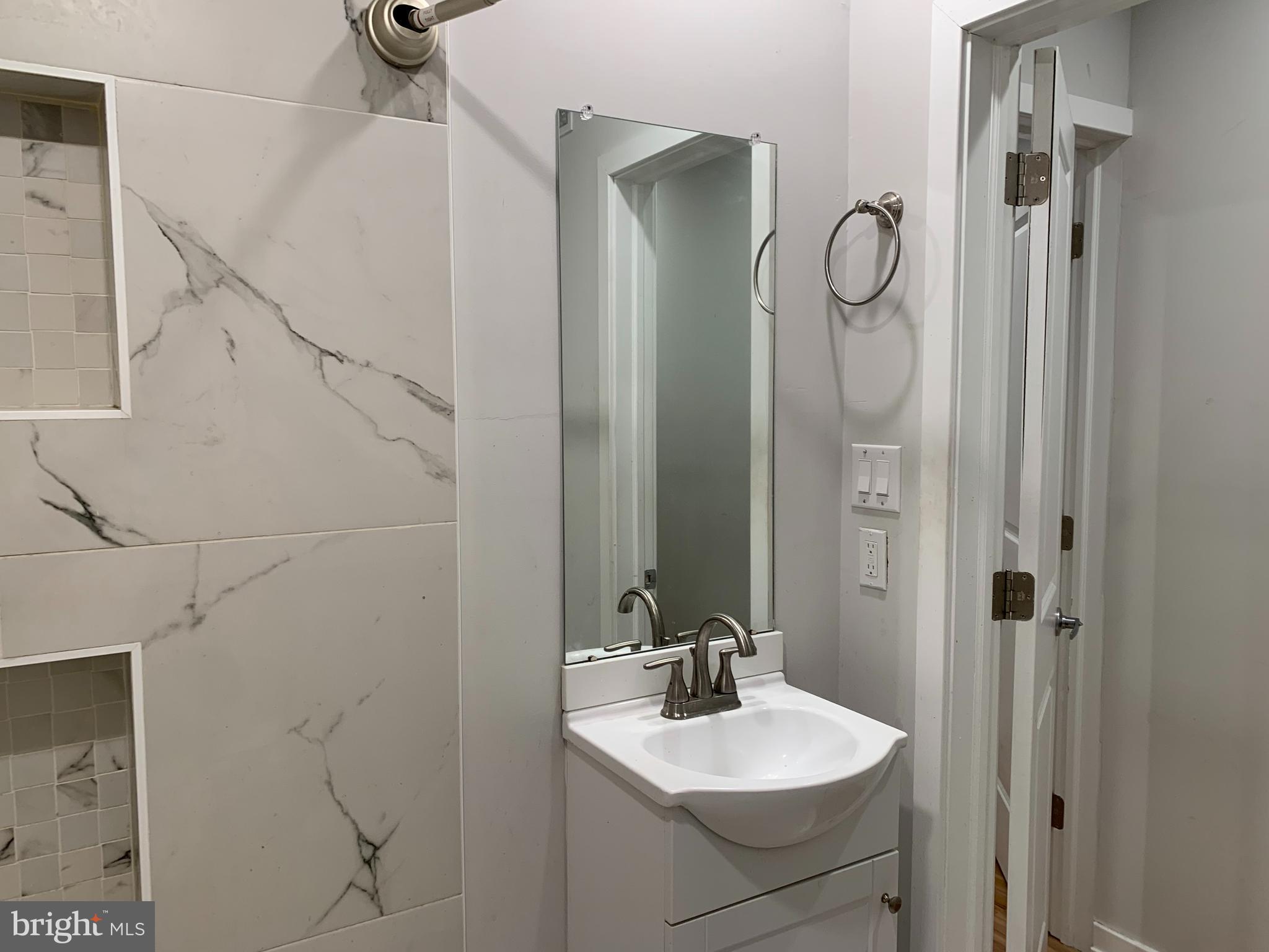 1268 South 27th Street, Unit 1 Philadelphia, PA 19146 - Photo 24 of 26 a bathroom with a sink and mirror