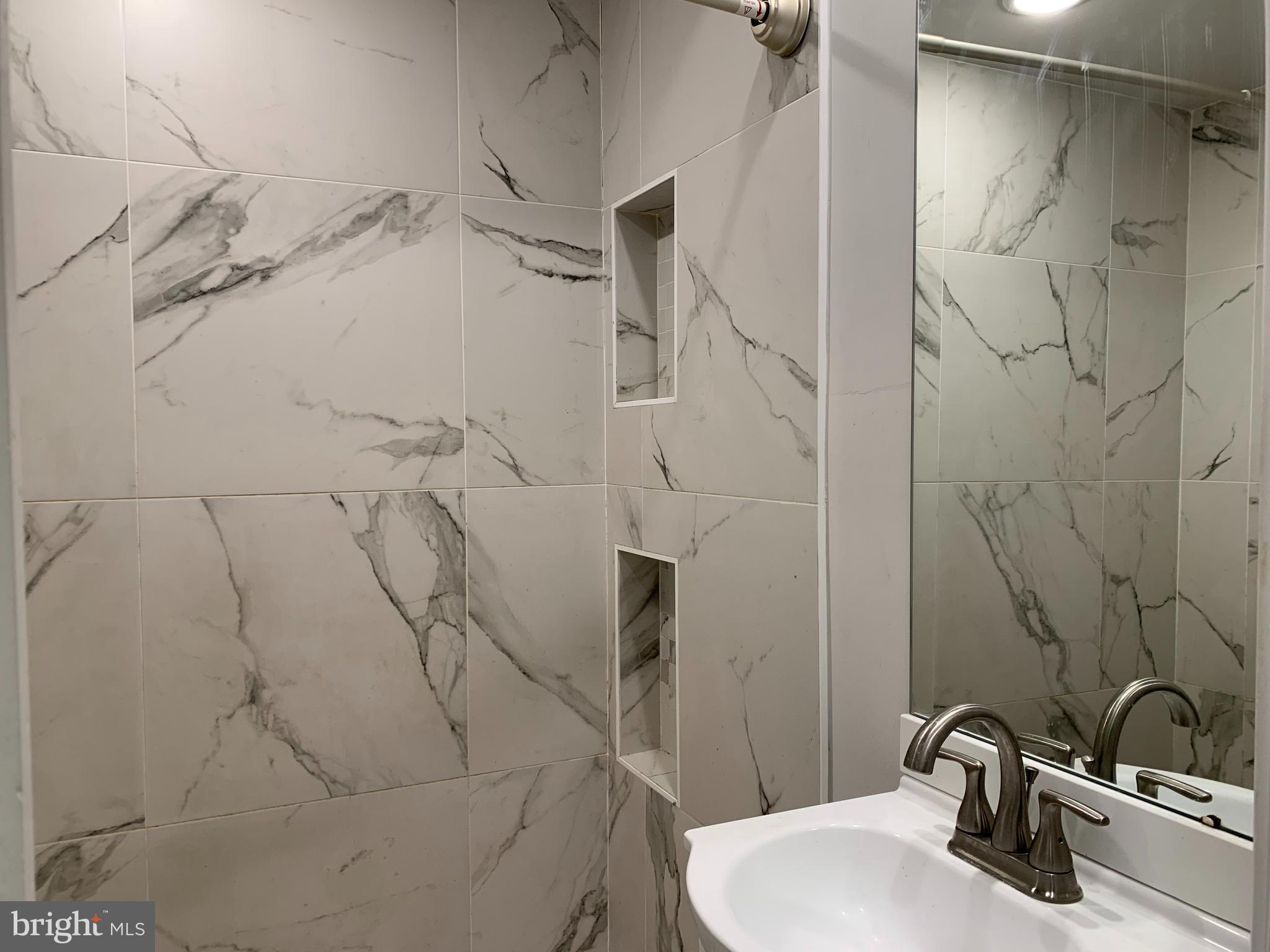 1268 South 27th Street, Unit 1 Philadelphia, PA 19146 - Photo 25 of 26 a bathroom with a sink and shower