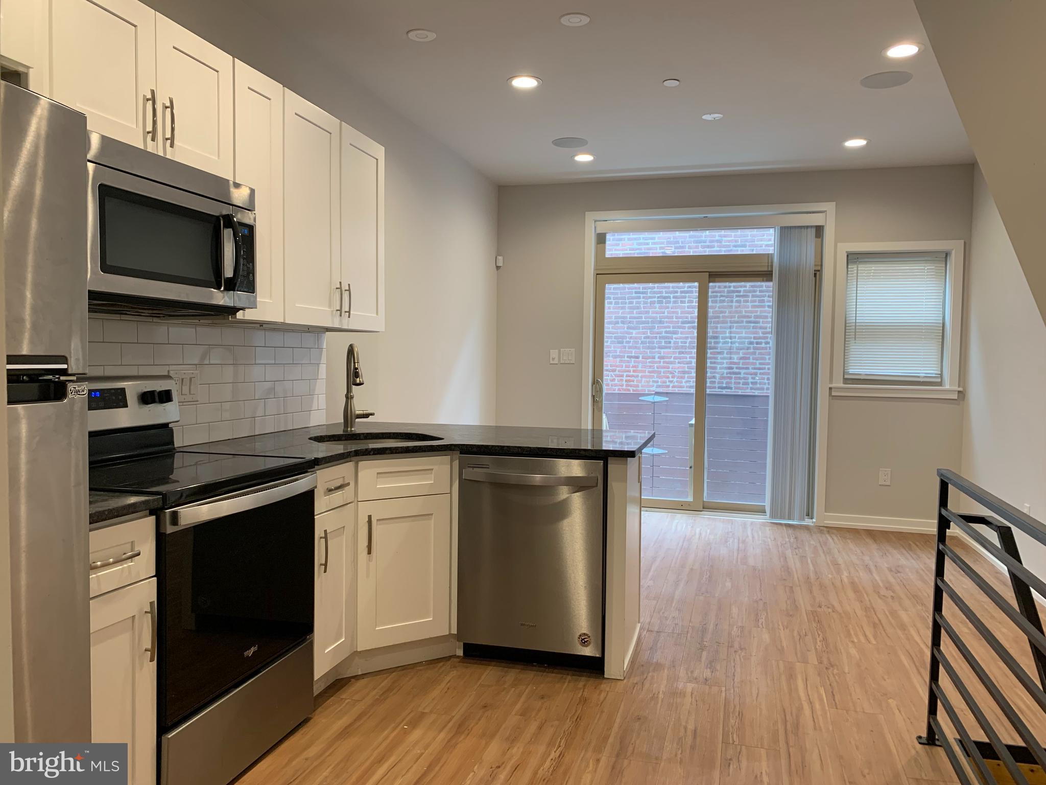1268 South 27th Street, Unit 1 Philadelphia, PA 19146 - Photo 5 of 26 a kitchen with a sink and a microwave