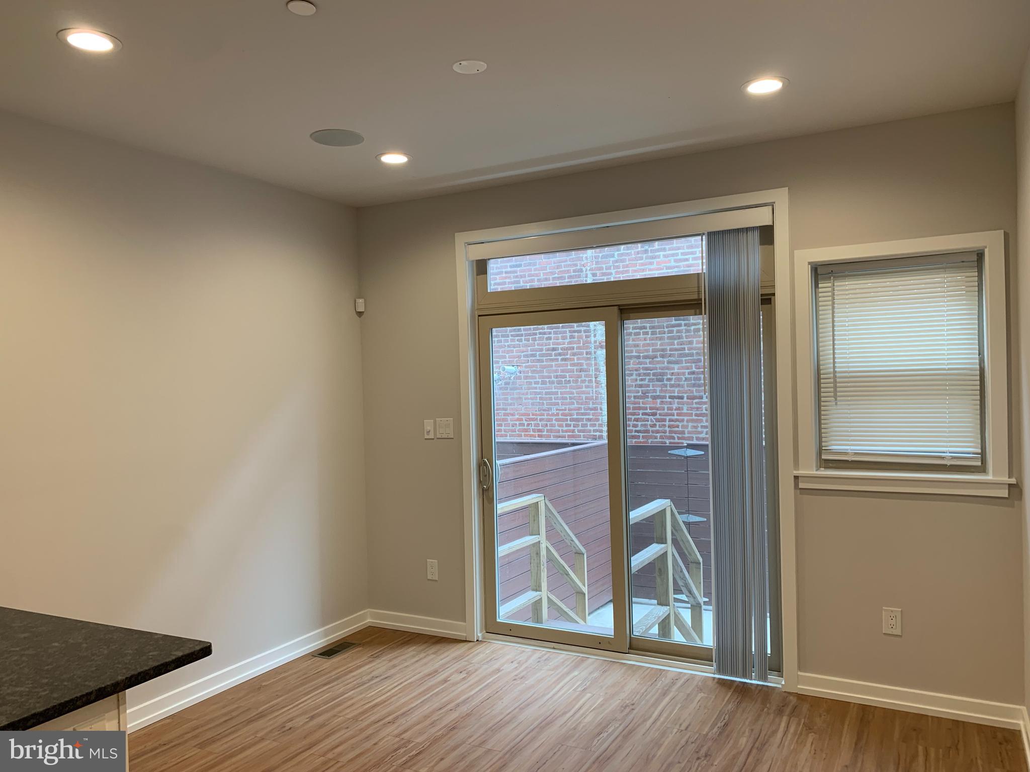 1268 South 27th Street, Unit 1 Philadelphia, PA 19146 - Photo 7 of 26 an empty room with wooden floor and entrance